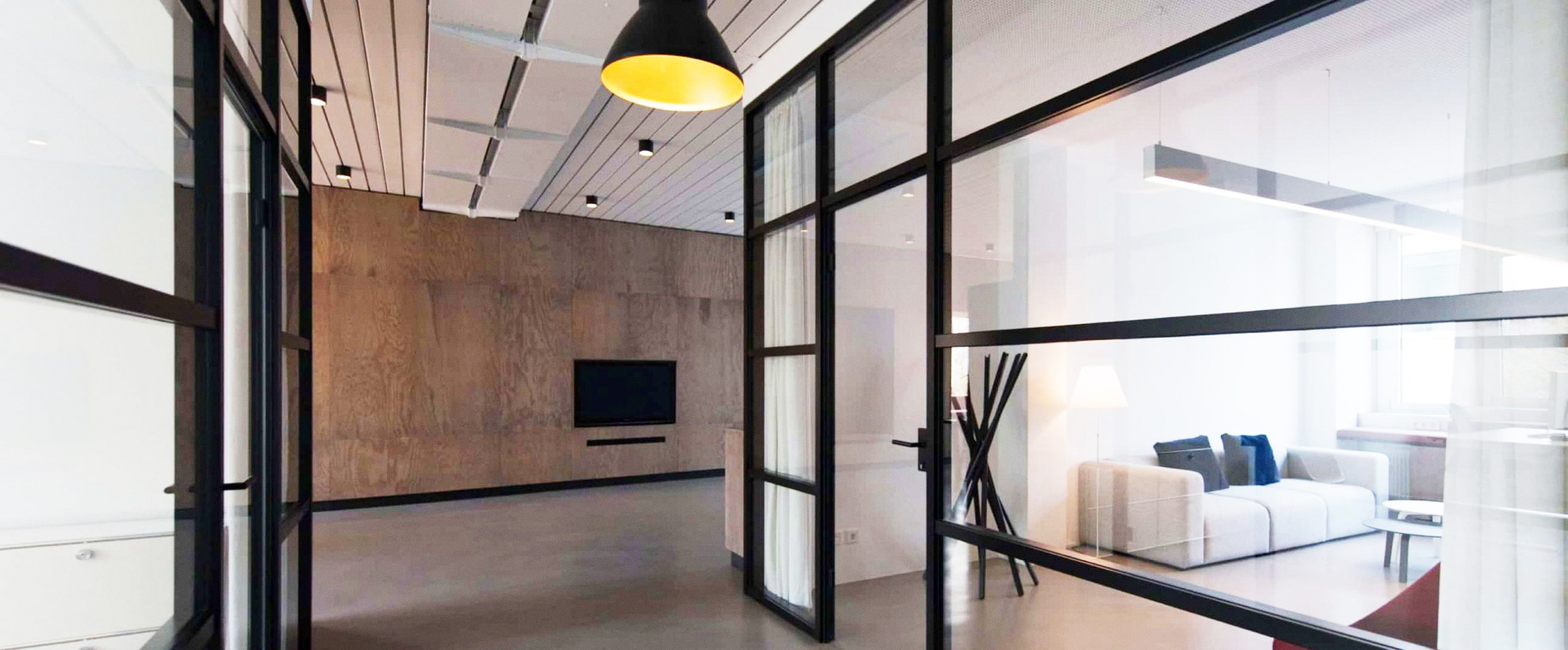 Modern commercial office interior with glass partitions and pendant lighting, reflecting NMGS's trusted make good and fit-out services