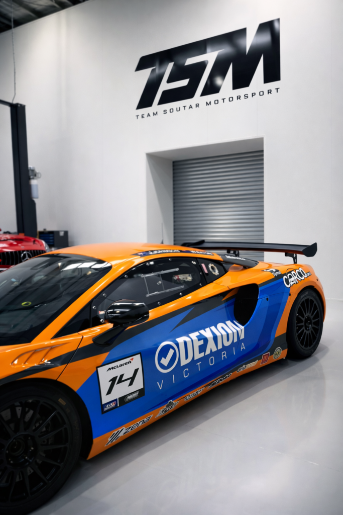 Dexion Victoria branded GT4 Australia 2026 race car with Jack Johnson at Team Soutar Motorsport workshop