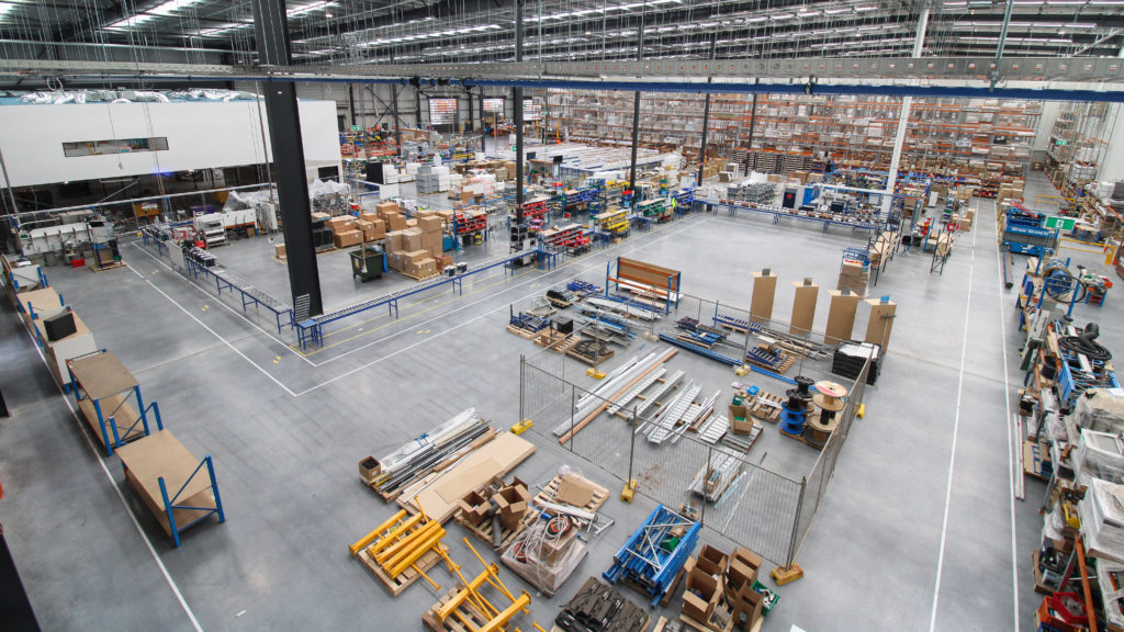 Wide-angle view of the Billi Australia distribution facility featuring Dexion Victoria’s warehouse storage solution, including selective pallet racking, pick and pack workstations, conveyor systems, and operational warehouse infrastructure designed to improve storage capacity and workflow efficiency.